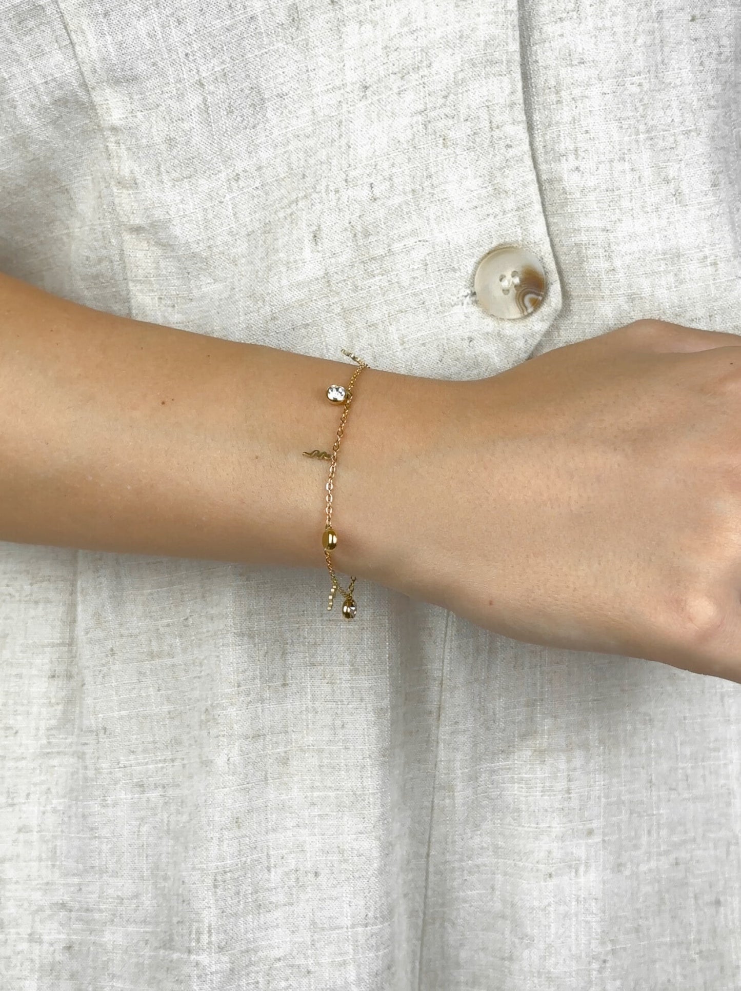 Pulseira de aço dourada cobras e zircônias