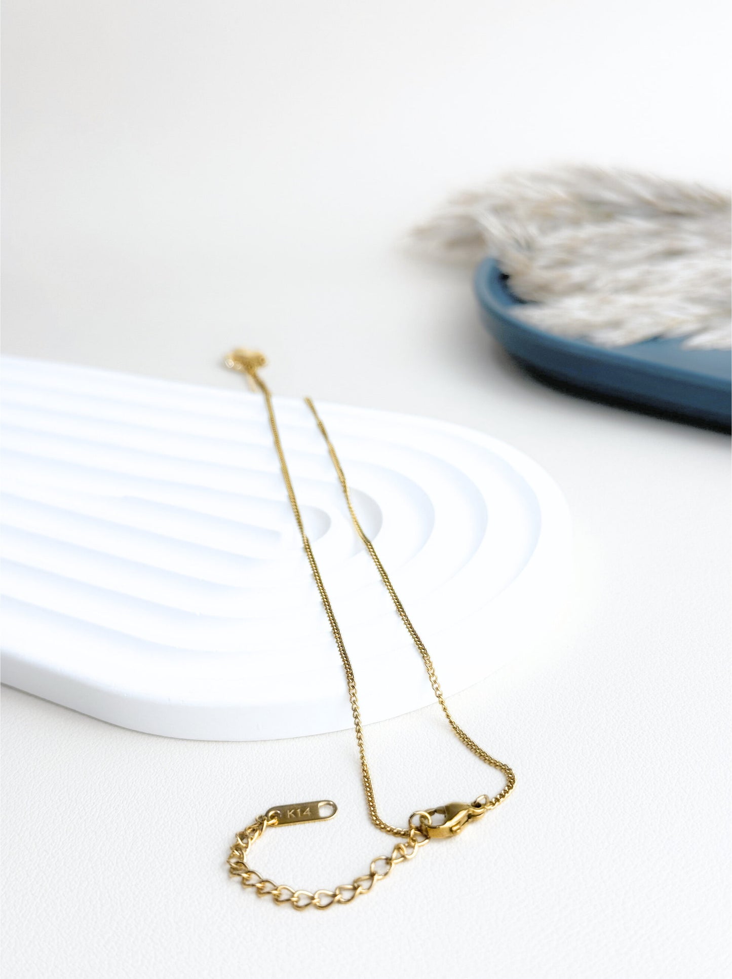 Collier feuille acier doré