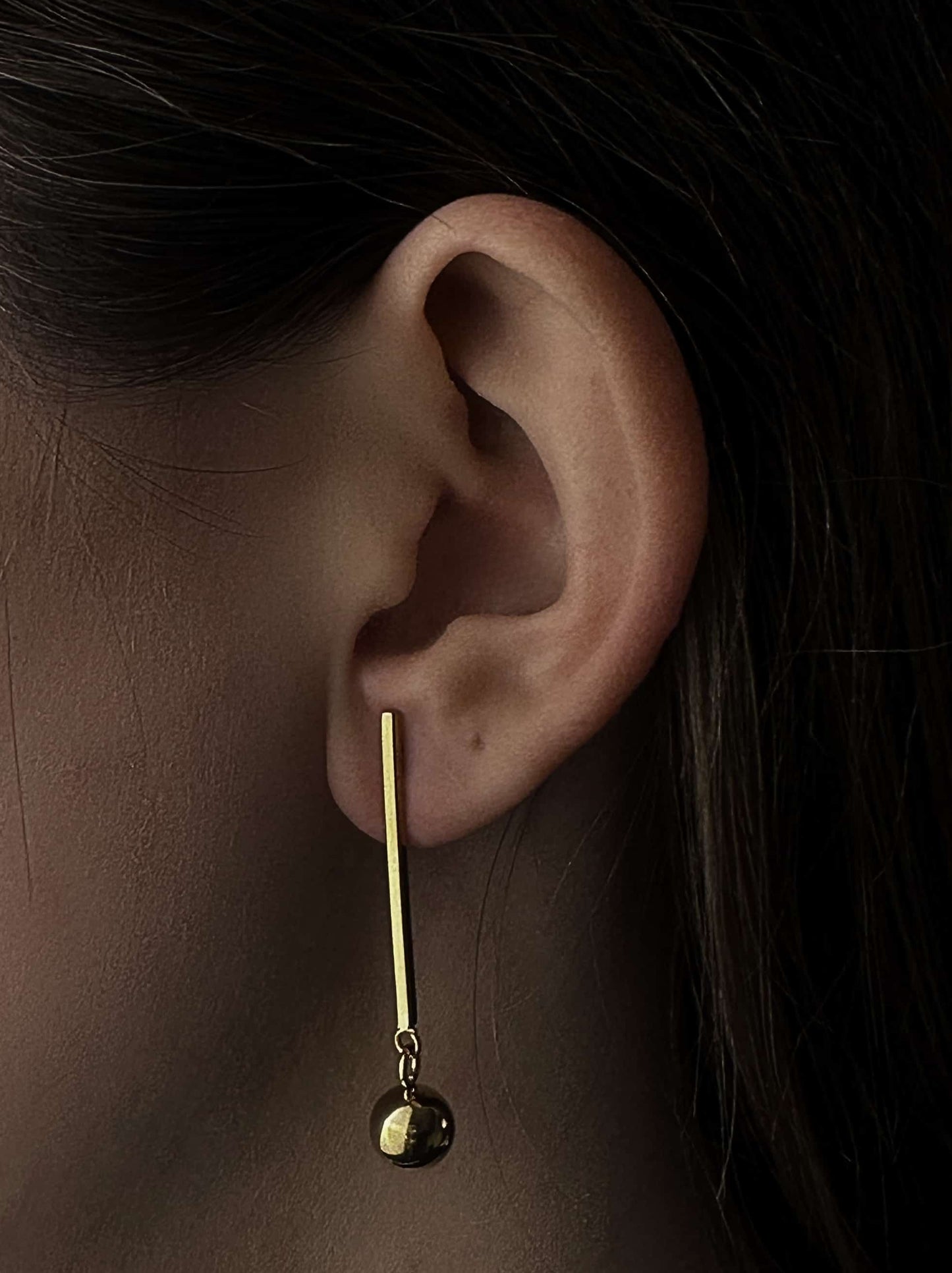 Long golden steel earrings