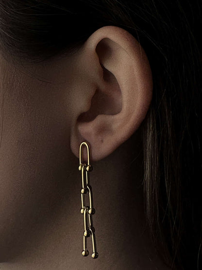 Long golden steel earrings