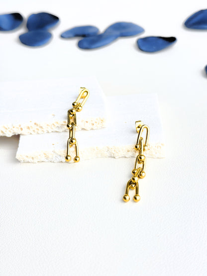 Long golden steel earrings