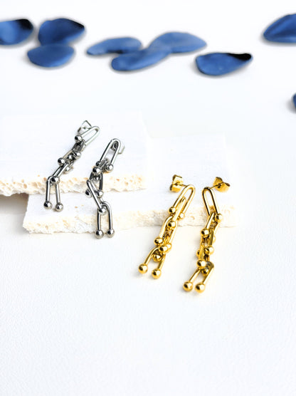 Long golden steel earrings