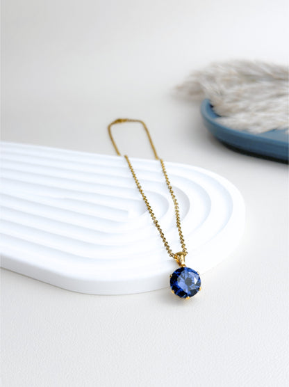 Collier acier doré cristal bleu