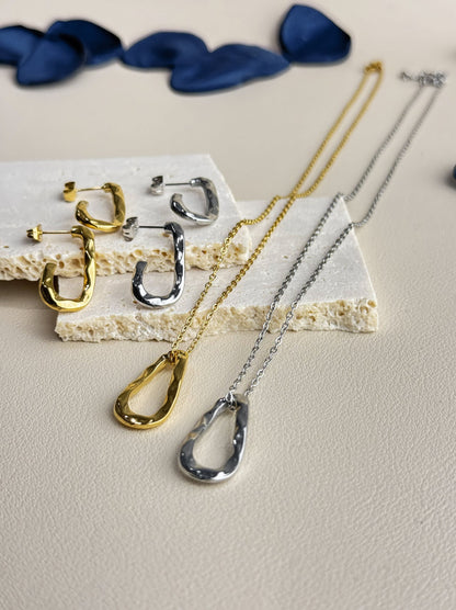 Golden steel necklace with irregular pendant