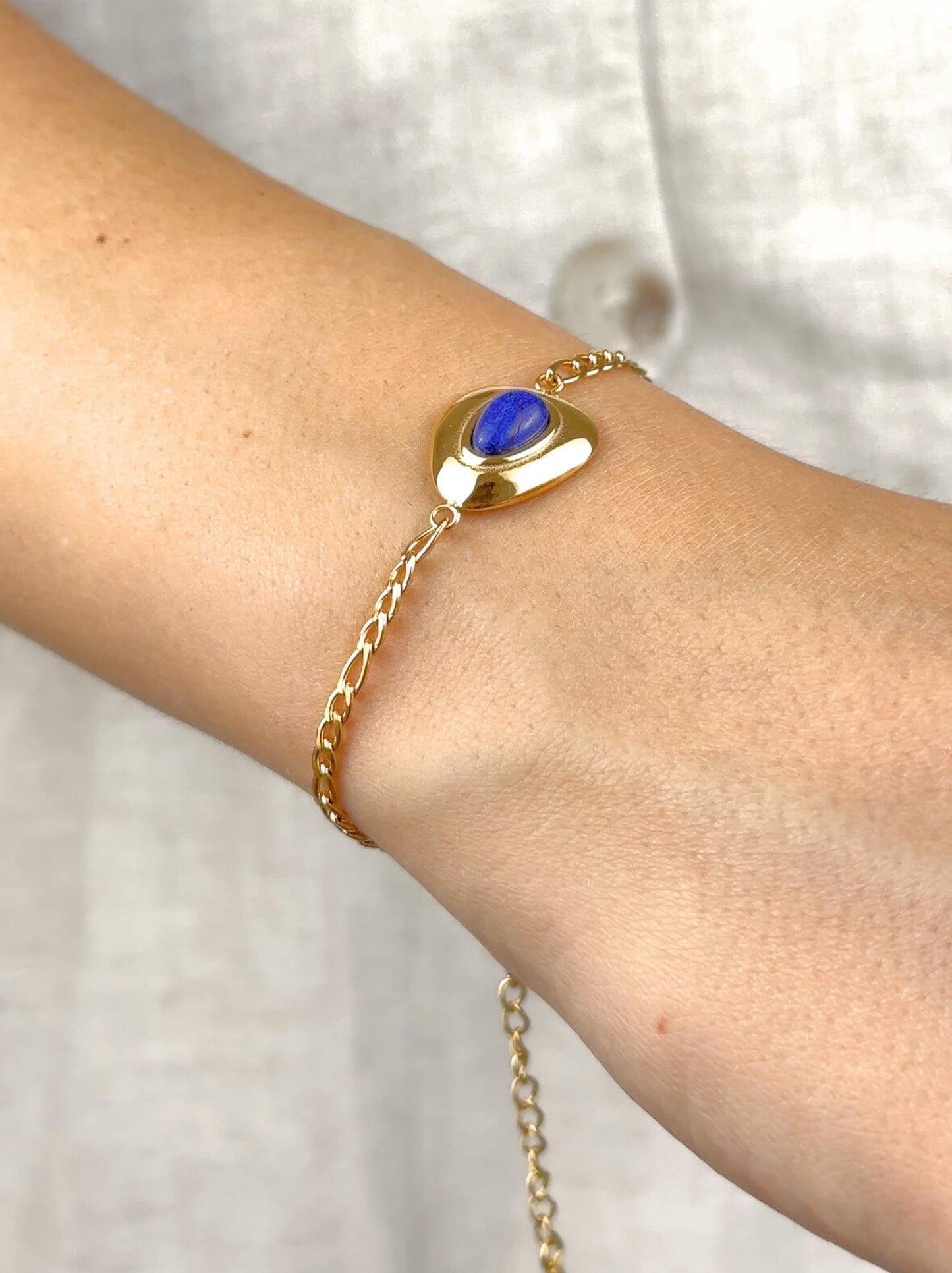 Golden steel bracelet with blue stone