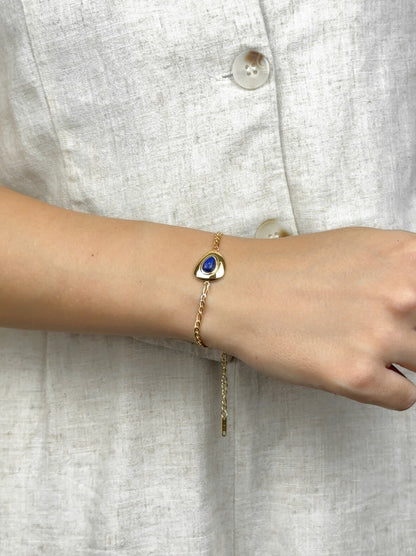 Golden steel bracelet with blue stone