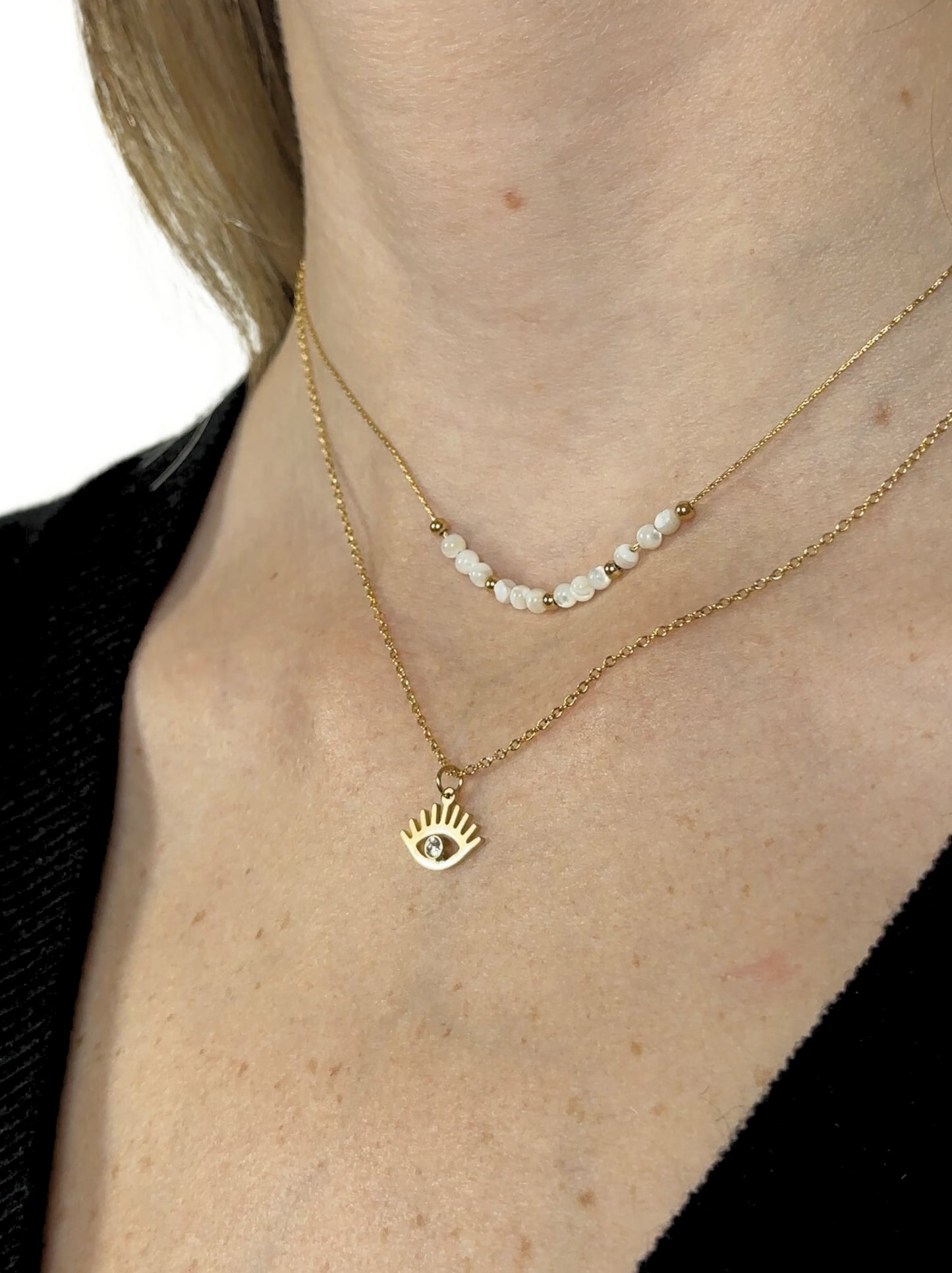 Golden steel pearl necklace with eye and zirconia