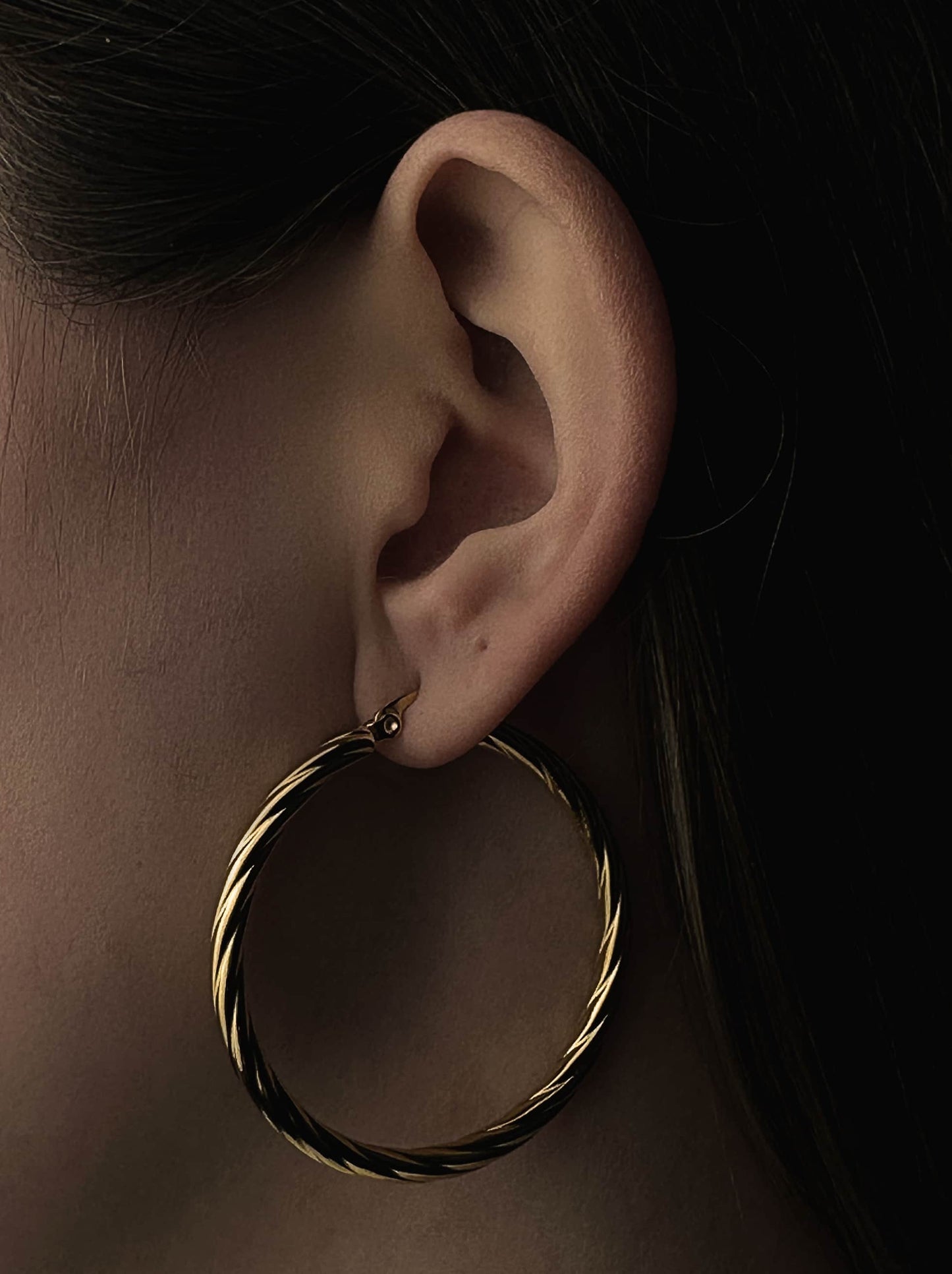 Twisted golden steel hoops